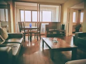 a living room with a couch and a table at Charming 96m2 fantastic view in Tourcoing