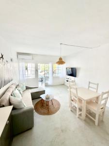 a living room with a couch and a table at Beach House Koko Apartment in Grand-Baie