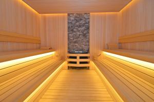 a sauna with wooden flooring and wooden benches at Hotel Aleksandar Conference & Spa in Žabljak