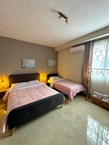 a bedroom with two beds and a window at Sunny apartment 1 in Serres