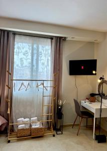 a room with a desk and a window with a table at Sunny apartment 1 in Serres
