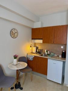 a small kitchen with a table and a table and chairs at Sunny apartment 1 in Serres
