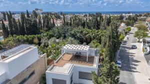 an aerial view of a white house with trees at DownTown Villa 2 in Paphos