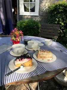 a table with two slices of cake on plates at Knochenhaus in Schmallenberg +32 photos