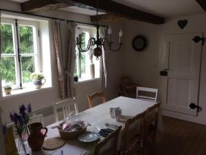 a dining room with a table and chairs and windows at Knochenhaus in Schmallenberg