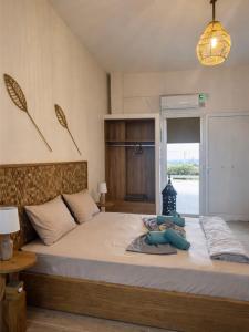 a bedroom with a large bed with a window at Seaview Apartments in Anavyssos