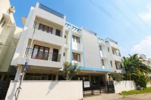 a white building with blue trim at Starlight Hotels OMR Thoraipakkam in Chennai