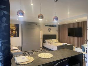 a bedroom with a bed and a flat screen tv at Family cottage in Epsom