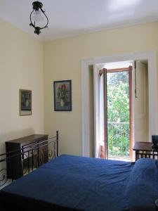 a bedroom with a blue bed and a window at DOMINO HOUSE Montariello in Sorrento
