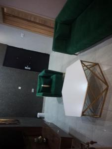 a room with a mirror and a green box on the wall at Mar'maris Residence Hotel in Owerri