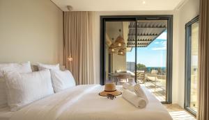 a bedroom with a bed with a hat on it at CADIAMARE in Zonza