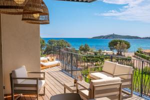 a balcony with chairs and a view of the ocean at CADIAMARE in Zonza