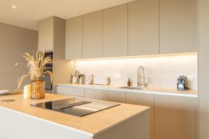 a kitchen with white cabinets and a sink at CADIAMARE in Zonza +130 photos
