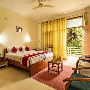 a bedroom with a bed and a large window at Theap Hospitality Enterprises in Noida