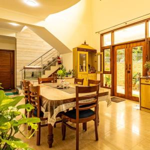 a dining room with a table and chairs at Theap Hospitality Enterprises in Noida +40 photos