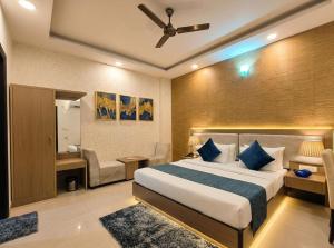 a hotel room with a bed and a couch at Sky Nest Plaza Inns Near Delhi International Airport in New Delhi +39 photos