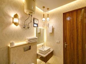 a bathroom with a sink and a toilet and a mirror at Sky Nest Plaza Inns Near Delhi International Airport in New Delhi