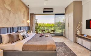 a bedroom with a large bed and a large window at Saffron Stays Augustus in Karjat +25 photos