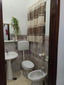 a bathroom with a toilet and a sink at A due passi dal mare in Praia a Mare +9 photos
