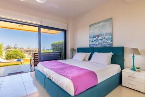 a bedroom with a large bed and a large window at Lavender Villas Chania in Agia Marina Nea Kydonias +167 photos
