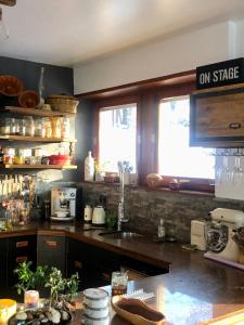 a kitchen with a counter top and two windows at Villa Aux Chênaies in Obernai