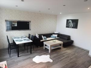 a living room with a couch and a table at Apartmán PP Tatry in Jezersko