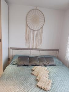 a bed with two pillows on top of it at Apartmán PP Tatry in Jezersko
