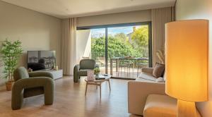 a living room with couches and chairs and a balcony at CADIAMARE in Zonza
