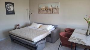 a small bedroom with a bed and a chair at A casa di Gina in Airasca