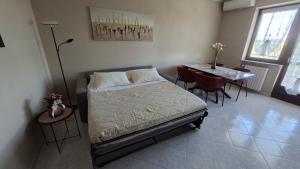 a bedroom with a bed and a table with chairs at A casa di Gina in Airasca +32 photos