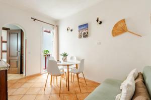 a living room with a table and chairs at Vicolo 35 Apartments in Trapani