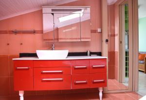 a bathroom with a red cabinet and a sink at Hotel Dias Apartment in Makrygialos