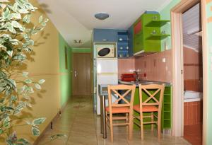 a kitchen with green cabinets and a table and chairs at Hotel Dias Apartment in Makrygialos +63 photos