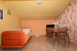 a room with a table and chairs and a bed at Hotel Dias Apartment in Makrygialos