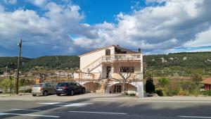 a white building with cars parked in front of it at Apartments Josip 2830 in Rab
