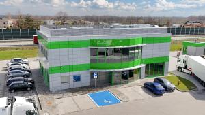 an office building with cars parked in a parking lot at Rest&Drive in Warszowice
