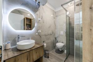 a bathroom with a sink and a shower at The Butterfly Apartment | Seafront & Amazing Views by PikHost in Lezhë +31 photos