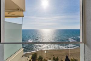 a view of the ocean from a window at The Butterfly Apartment | Seafront & Amazing Views by PikHost in Lezhë