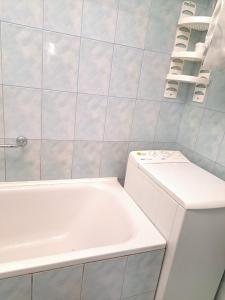a bathroom with a tub and a toilet and a sink at Квартира Шевченка in Lutsk