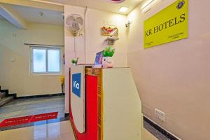 a lobby of a hotel with a sign on the wall at Via KR in Chennai