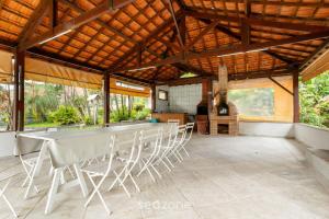 a large table and chairs in a pavilion at Studio in Condo w/ Pool in Downtown QUI0605 in Poços de Caldas