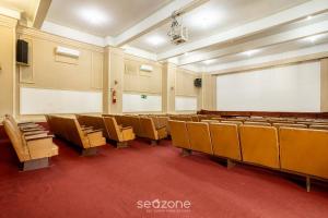an empty lecture room with chairs and a whiteboard at Studio in Condo w/ Pool in Downtown QUI0605 in Poços de Caldas +55 photos