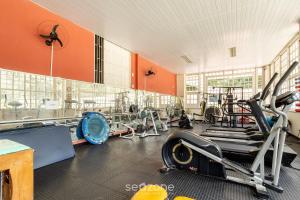 a gym with a lot of equipment in a room at Studio in Condo w/ Pool in Downtown QUI0605 in Poços de Caldas