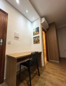 a room with a wooden table and a chair at STUDIO Flat B in Betim