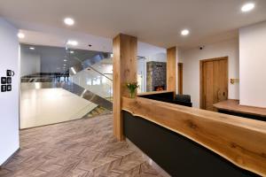 a lobby with a staircase in a house at APLEND Lake Resort in Štrbské Pleso