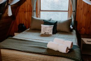 a bedroom with a bed with two towels on it at Emerald Escape in Grayling +42 photos