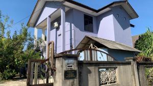 a house with a gate in front of it at Dikmad Studio Room Bukit Mentok, Kemaman in Cukai