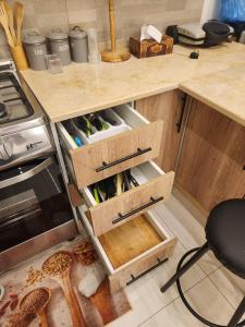 a kitchen with wooden drawers filled with wine bottles at Ranachalet-1 in Ash Shāghūr