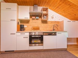 a kitchen with white cabinets and a sink at Wieshof in Kaltenbach