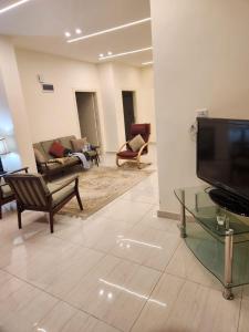 a living room with couches and a flat screen tv at Ranachalet-1 in Ash Shāghūr